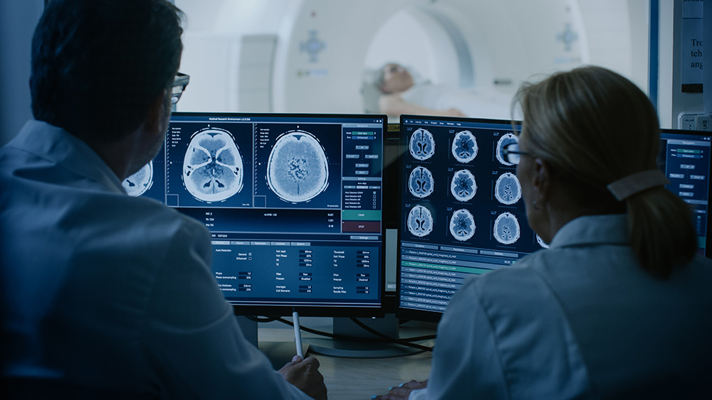 In Control Room Doctor and Radiologist Discuss Diagnosis